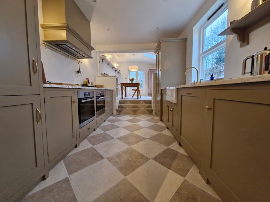 Bespoke kitchen by Pymm Kitchens with Shaker cabinetry and marble worktops