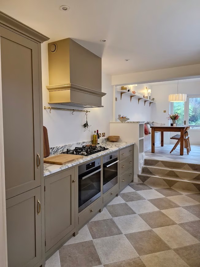 Bespoke kitchen with Shaker cabinetry, marble worktops and checkerboard floor